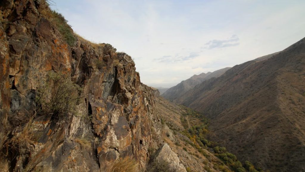 Explore the rugged cliffs and expansive views of this mountain gorge at daytime, showcasing natural beauty.